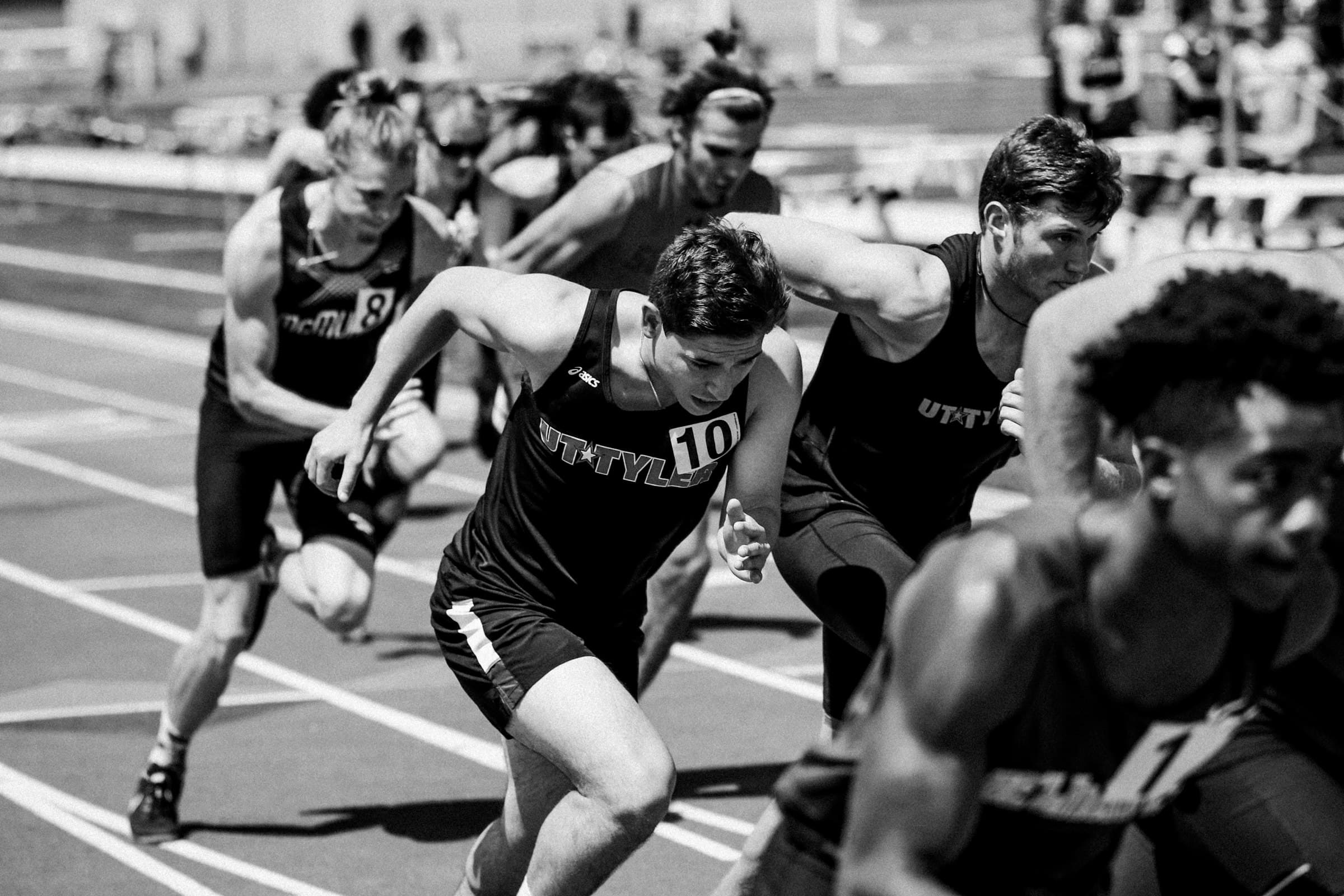 Sprinters exploding off the start line during a track race